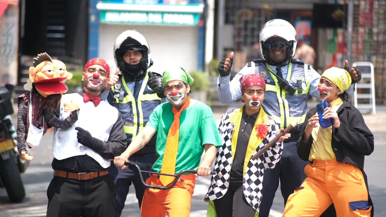 Artistas caracterizados y agentes de tránsito interactúan con ciudadanos durante una intervención pedagógica de la campaña ‘Pensala Vé’, que llevó mensajes de cultura vial y respeto por la vida a las calles de Cali.