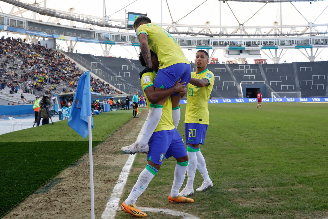 Brazil's Andrey Santos carries teammate Marcos Leonardo after he scored his side's 2nd goal against Tunisia during a FIFA U-20 World Cup round of 16 soccer match at La Plata Stadium in La Plata, Argentina, Wednesday, May 31, 2023. (AP Photo/Ivan Fernandez)