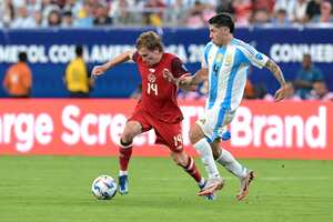 Canada's forward #14 Jacob Shaffelburg fights for the ball with Argentina's defender #04 Gonzalo Montiel during the Conmebol 2024 Copa America tournament semi-final football match between Argentina and Canada at MetLife Stadium, in East Rutherford, New Jersey on July 9, 2024. (Photo by JUAN MABROMATA / AFP)