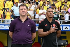 Colombia's Argentine head coach Nestor Lorenzo (L) and assistant coach Luis Amaranto Perea listen to the anthem before the 2026 FIFA World Cup South American qualifiers football match between Colombia and Peru, at the Metropolitano Roberto Melendez stadium in Barranquilla, Colombia, on June 6, 2025. (Photo by Luis ACOSTA / AFP)