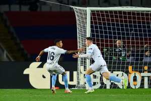 El defensor español del Girona Valery Fernandez (der.) celebrate un gol con el brasilero Savio Moreira, en el duelo de la Liga española ante el barcelona este domingo 11 de diciembre de 2023. /Foto Pau BARRENA / AFP)