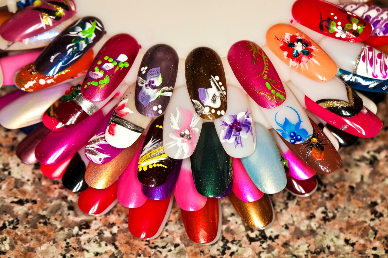 different types of hand painted fingernail designs displayed on fake acrylic fingernails