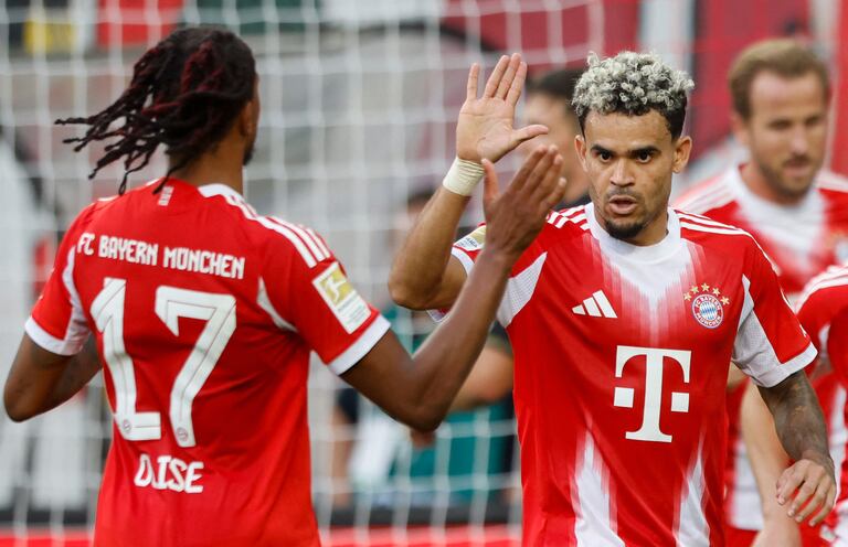 Bayern Munich's Colombian forward #14 Luis Diaz (R) celebrates scoring the 0-2 goal with his teammates including Bayern Munich's French midfielder #17 Michael Olise during the German first division Bundesliga football match between FC Augsburg and FC Bayern Munich in Augsburg, southern Germany, on August 30, 2025. (Photo by Michaela STACHE / AFP) / DFL REGULATIONS PROHIBIT ANY USE OF PHOTOGRAPHS AS IMAGE SEQUENCES AND/OR QUASI-VIDEO