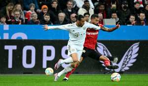 Bayern Munich's German midfielder Leroy Sane (L) and Leverkusen's German midfielder Kerem Demirbay vie for the ball during the German first division Bundesliga football match between Bayer Leverkusen and Bayern Munich in Leverkusen on March 19, 2023. (Photo by INA FASSBENDER / AFP) / DFL REGULATIONS PROHIBIT ANY USE OF PHOTOGRAPHS AS IMAGE SEQUENCES AND/OR QUASI-VIDEO