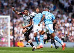 Fulham's Rodrigo Muniz, left, challenges for the ball with Manchester City's Manuel Akanji during the English Premier League soccer match between Fulham and Manchester City at the Craven Cottage Stadium in London, Saturday, May 11, 2024. (AP Photo/Kirsty Wigglesworth)