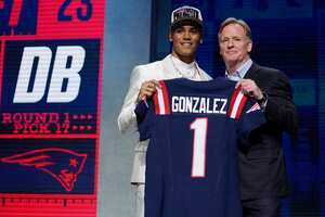 El back defensivo de Oregón, Christian González, a la izquierda, posa con el comisionado de la NFL, Roger Goodell, luego de ser elegido por los Patriotas de Nueva Inglaterra con la selección número 17 durante la primera ronda del draft de fútbol americano de la NFL