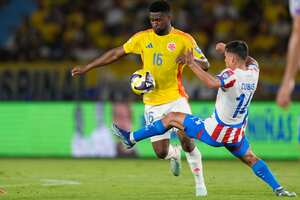 Colombia's Jefferson Lerma, left, and Paraguay's Andres Cubas battle for the ball during a World Cup 2026 qualifying soccer match at Metropolitano Stadium in Barranquilla, Colombia, Tuesday, March 25, 2025. (AP Photo/Fernando Vergara)