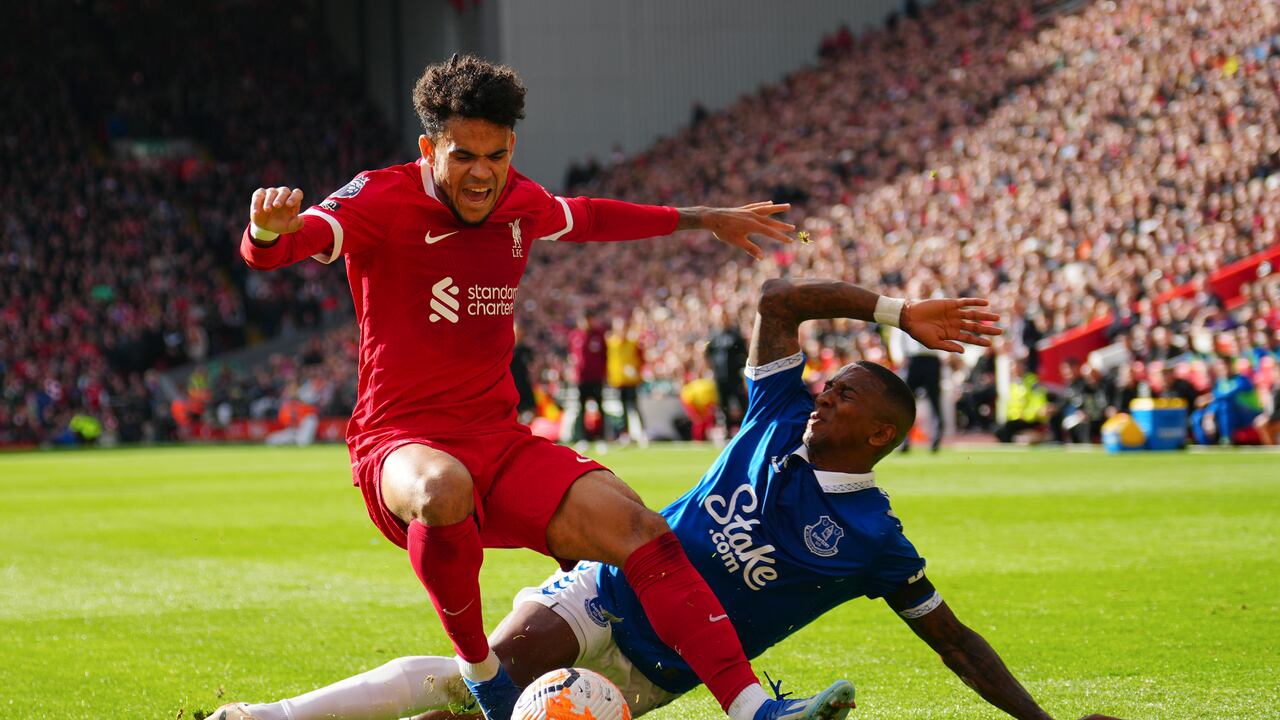 Liverpool's Luis Diaz, left, challenges for the ball with Everton's Ashley Young during the English Premier League soccer match between Liverpool and Everton, at Anfield in Liverpool, England, Saturday, Oct. 21, 2023. (AP Photo/Jon Super)