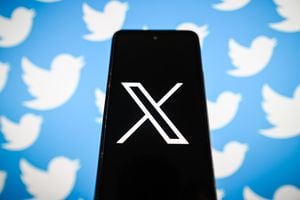 POLAND - 2023/07/25: In this photo illustration, a New twitter Logo X is displayed on a smartphone with the old twitter logo in the background. (Photo Illustration by Omar Marques/SOPA Images/LightRocket via Getty Images)