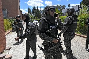 Police officers stand guard at the Vertical Cemetery before the funeral of slain Ecuadorean presidential candidate Fernando Villavicencio, a day after his assassination, in Quito, on August 10, 2023. Villavicencio, the second most popular candidate in the presidential race according to recent opinion polls, was shot dead while leaving a rally in the nation's capital on Wednesday, prompting President Guillermo Lasso to declare a state of emergency and blame the assassination on organized crime. Villavicencio, a 59-year-old anti-corruption crusader who had complained of receiving threats, was murdered as he was leaving a stadium in Quito after holding a campaign rally, officials said. (Photo by Rodrigo BUENDIA / AFP)