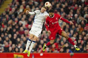 Atalanta's Teun Koopmeiners, left, and Liverpool's Joe Gomez fight for the ball during the Europa League quarter final first leg soccer match between Liverpool and Atalanta, at the Anfield stadium in Liverpool, England, Thursday, April 11, 2024. (AP Photo/Jon Super)