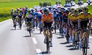 Rohan Dennis from Australia pedals with the pack during the first stage, a 178 km race between La Grande Beroche and Romont at the 75th Tour de Romandie UCI ProTour cycling race in Romont, Switzerland, Wednesday, April 27, 2022. (Jean-Christophe Bott/Keystone via AP)
