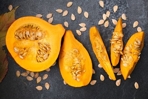Orange pumpkin cut into pieces with seeds