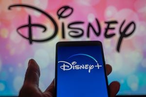 Disney + streaming icon displayed on smartphone with Walt Disney seen in the background. On 12 August 2023 in Brussels, Belgium.  (Photo illustration by Jonathan Raa/NurPhoto via Getty Images)
